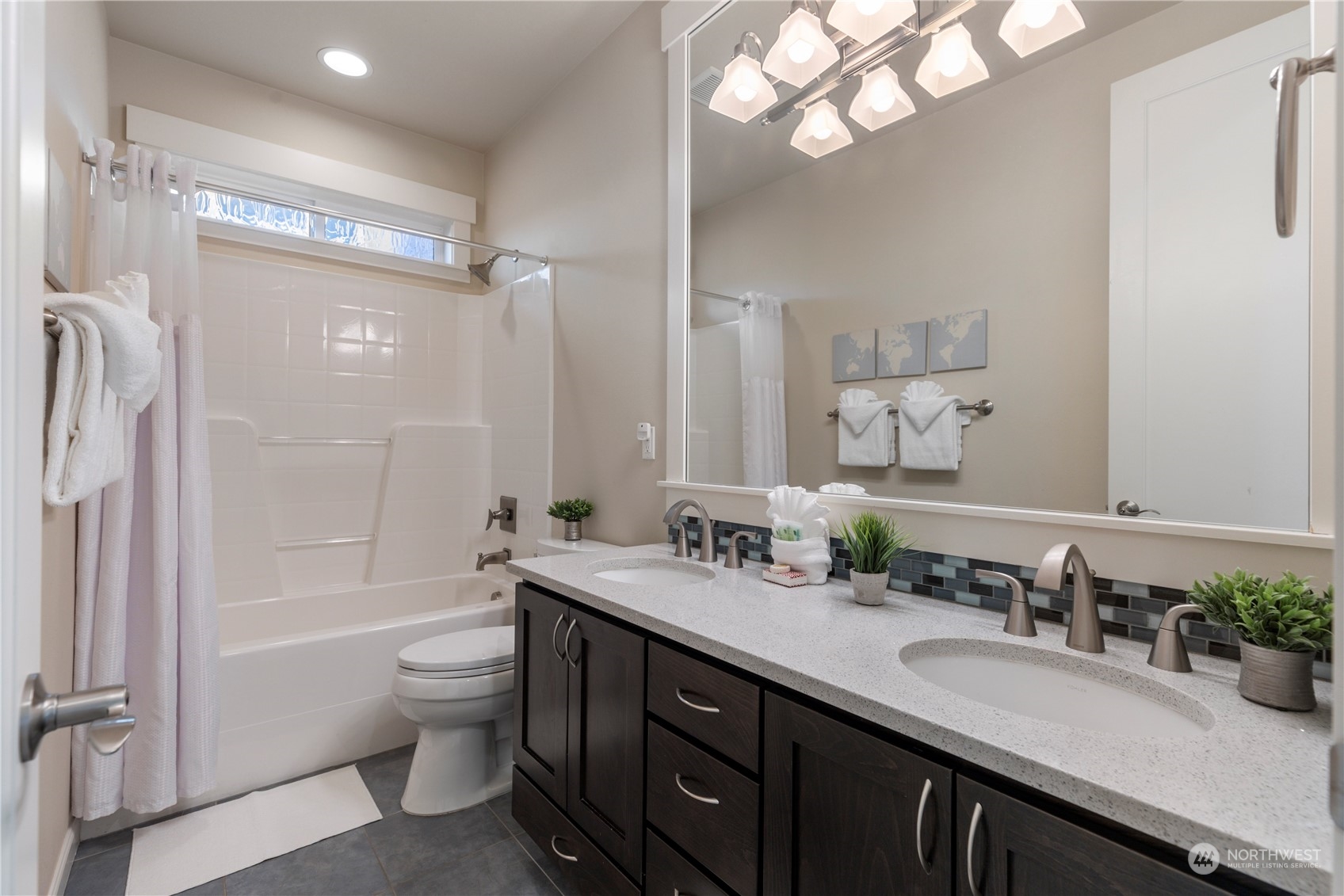 3318 Lake Washington Boulevard North Renton, WA 98056 - Photo 27 of 40 a bathroom with a granite countertop sink a toilet a mirror a vanity and shower