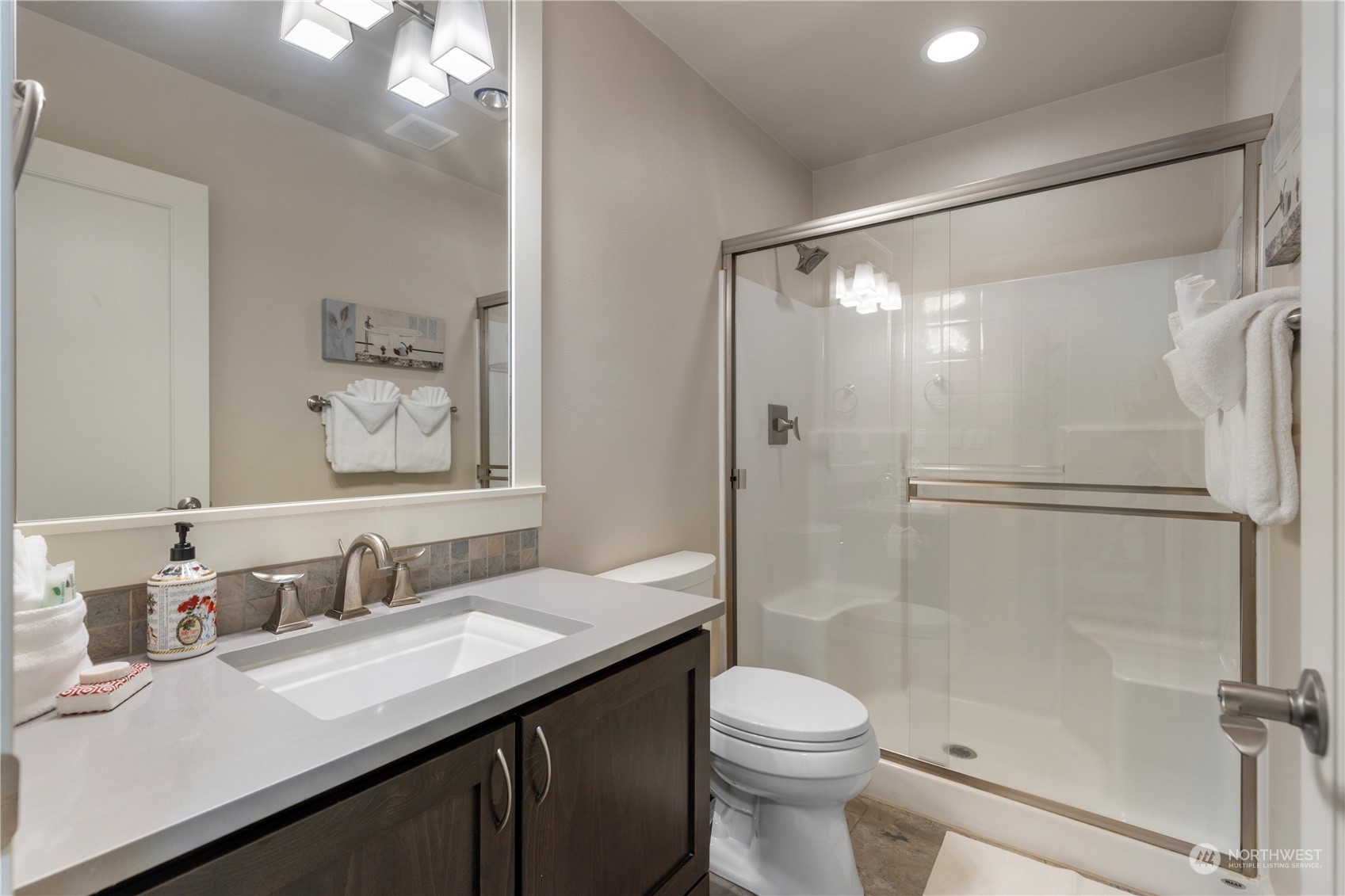 3318 Lake Washington Boulevard North Renton, WA 98056 - Photo 36 of 40 a bathroom with a granite countertop sink toilet and shower