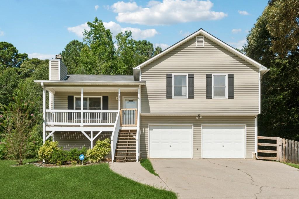 a front view of a house with a yard and glass windows