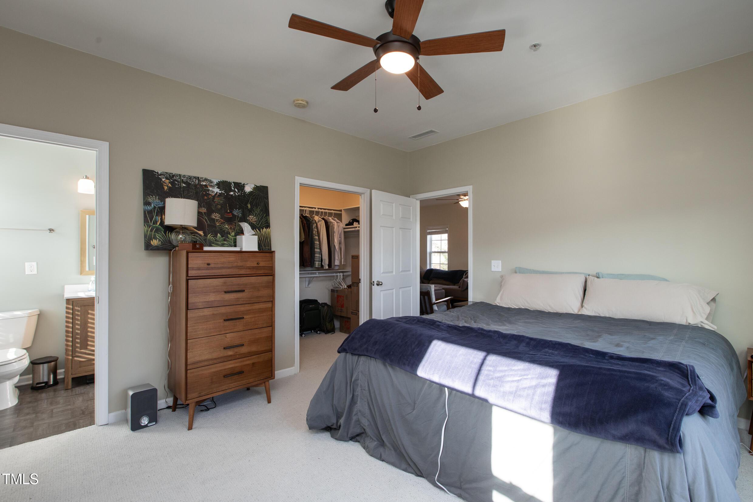 1208 Wall Street Durham, NC 27701 - Photo 11 of 16 a bedroom with a bed and a chandelier