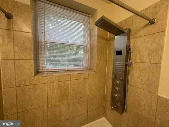 a bathroom with a shower and a sink