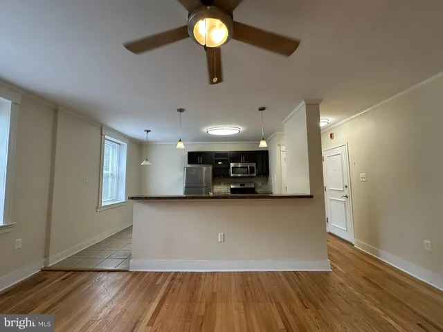 a view of kitchen and wooden floor
