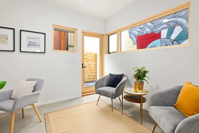 a living room with furniture and a potted plant