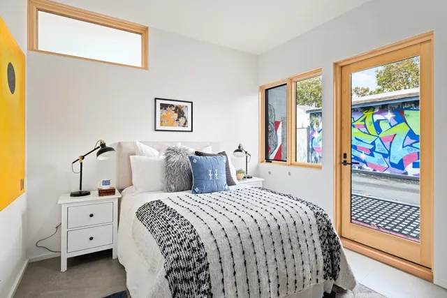 a bedroom with a bed and a window