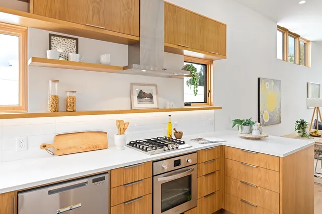 a kitchen with stainless steel appliances granite countertop a refrigerator and a sink