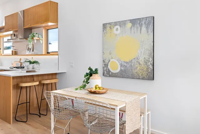 a living room with patio furniture and a potted plant