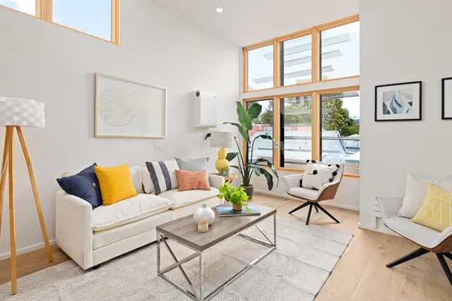 a living room with furniture and floor to ceiling windows