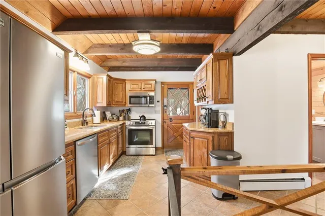 a kitchen with a stove a sink and a refrigerator
