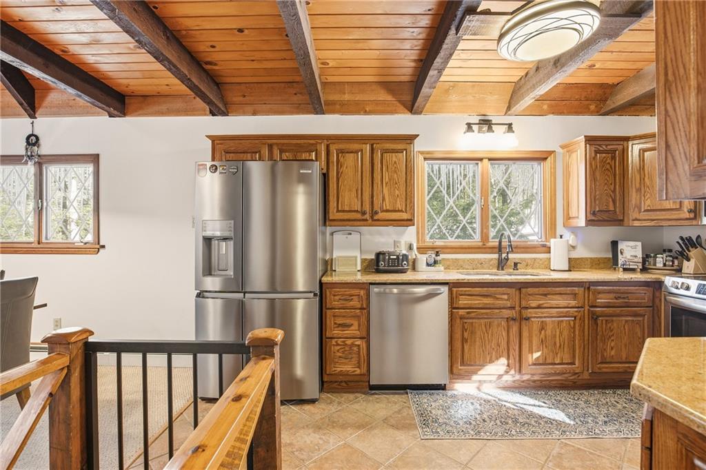 427 Wenatchee Path Central City, PA 15926 - Photo 7 of 42 a kitchen with stainless steel appliances granite countertop a refrigerator and wooden cabinets