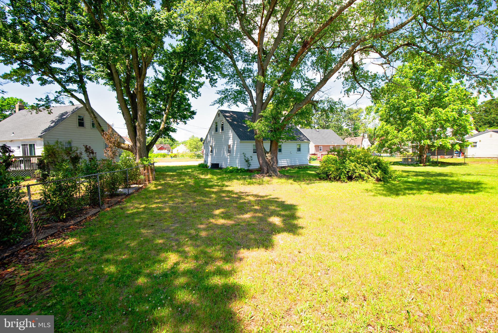 214 David Place Magnolia, NJ 08049 - Photo 19 of 21 a view of a house with a big yard and large trees