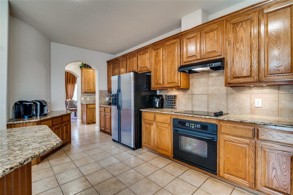1113 Waterford Way Allen, TX 75013 - Photo 13 of 36 a kitchen with stainless steel appliances granite countertop a refrigerator a stove and a sink