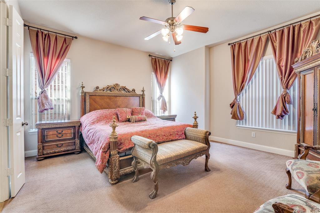 1113 Waterford Way Allen, TX 75013 - Photo 17 of 36 a bedroom with a bed and a chandelier