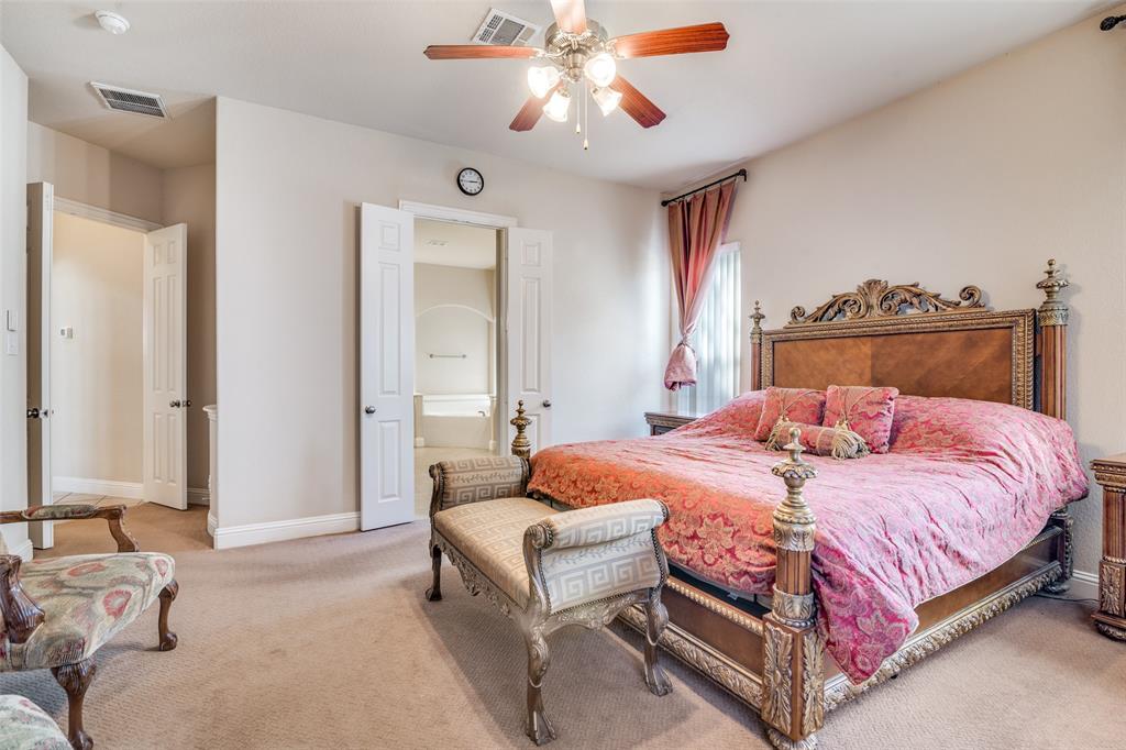 1113 Waterford Way Allen, TX 75013 - Photo 18 of 36 a bedroom with a bed and a chandelier fan