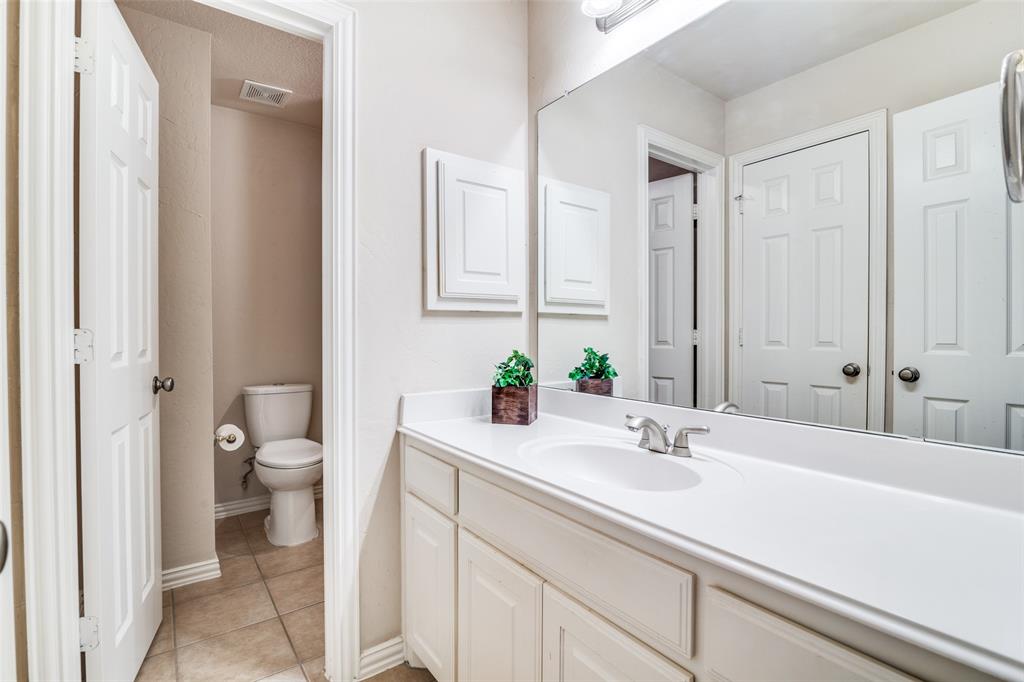 1113 Waterford Way Allen, TX 75013 - Photo 28 of 36 a bathroom with a sink a toilet and a large mirror