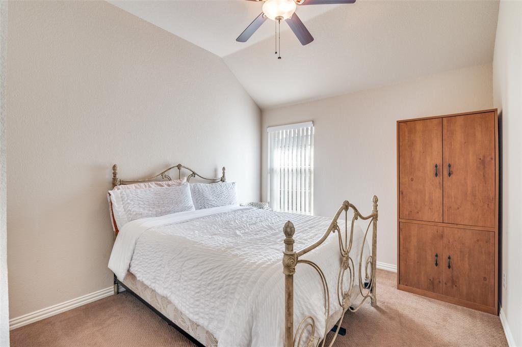 1113 Waterford Way Allen, TX 75013 - Photo 31 of 36 a bedroom with a bed and a chandelier