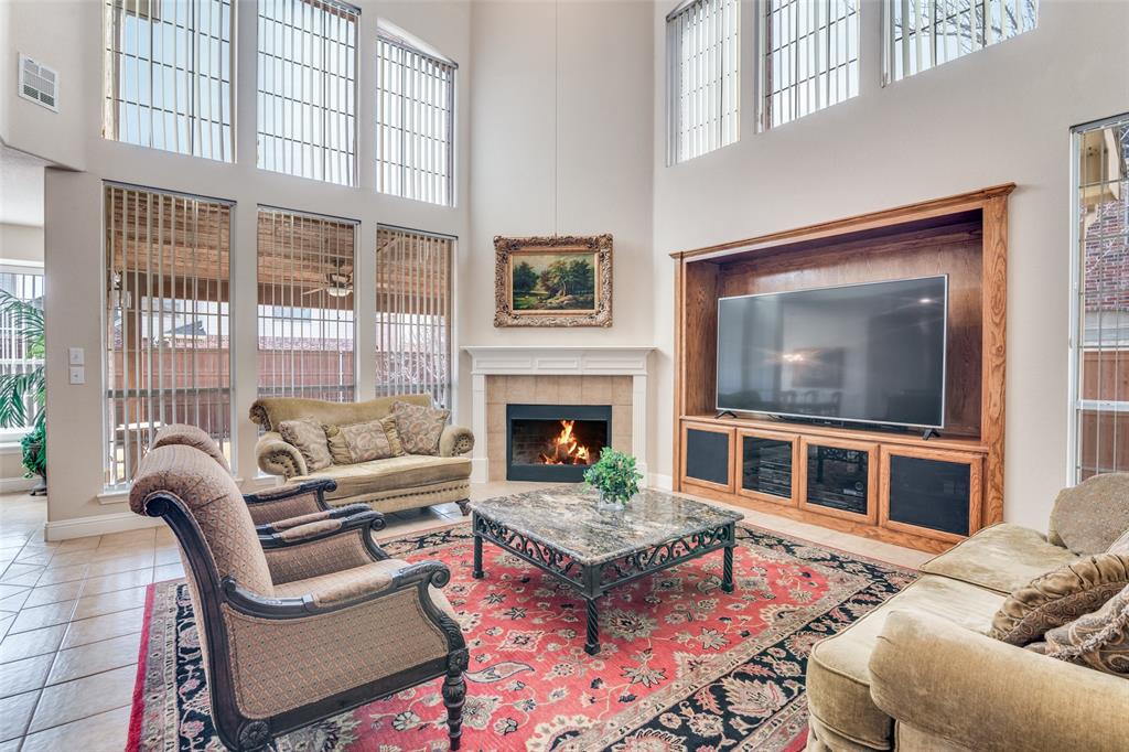 1113 Waterford Way Allen, TX 75013 - Photo 7 of 36 a living room with furniture a rug and a fireplace