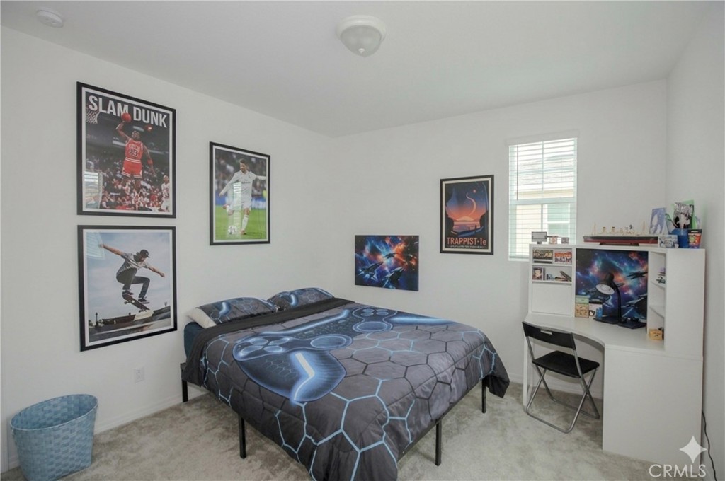 8529 Exposition Street Chino, CA 91708 - Photo 19 of 42 a bedroom with a bed and a desk