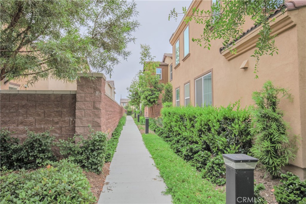 8529 Exposition Street Chino, CA 91708 - Photo 2 of 42 a view of a pathway with house on both side