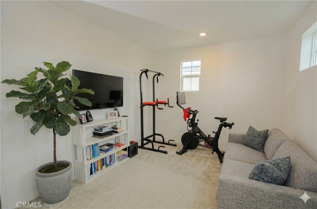 8529 Exposition Street Chino, CA 91708 - Photo 22 of 42 a living room with furniture a potted plant and a flat screen tv