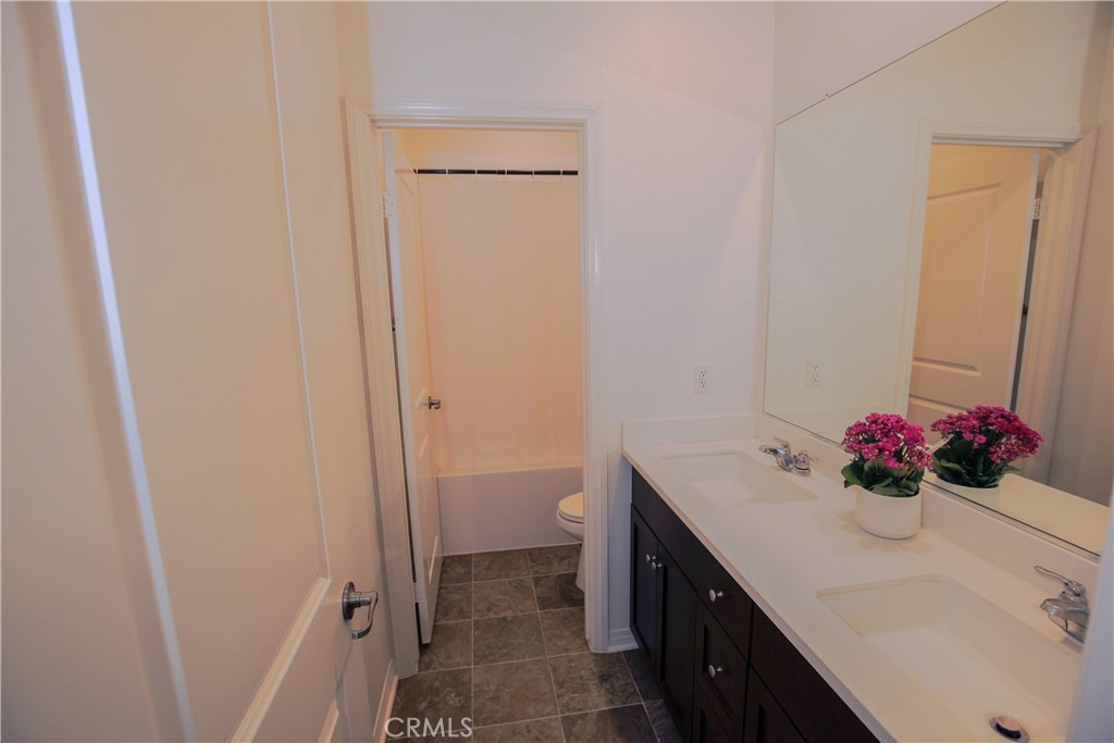 8529 Exposition Street Chino, CA 91708 - Photo 23 of 42 a bathroom with a sink vanity and a mirror