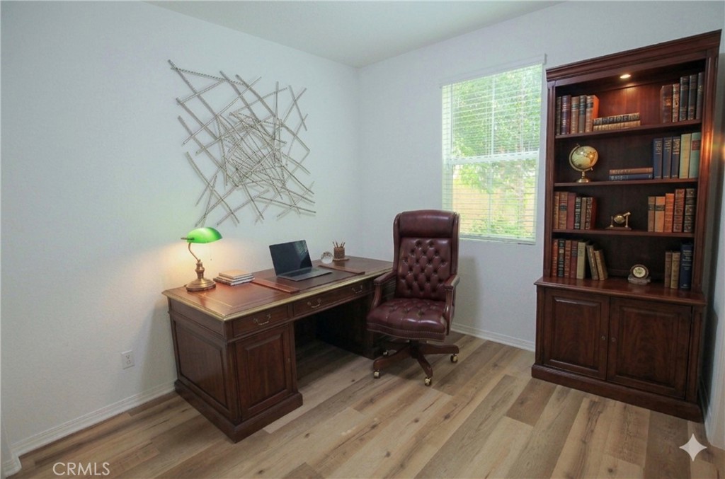 8529 Exposition Street Chino, CA 91708 - Photo 25 of 42 a view of workspace with wooden floor lounge chair windows cabinet