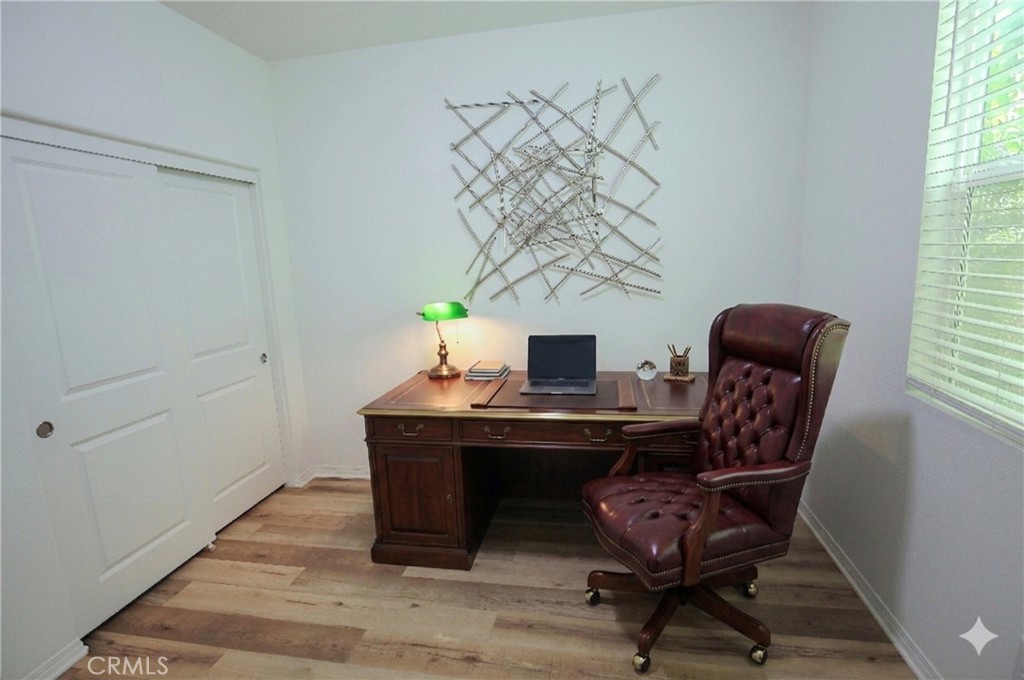 8529 Exposition Street Chino, CA 91708 - Photo 26 of 42 a view of a workspace with furniture and wooden floor
