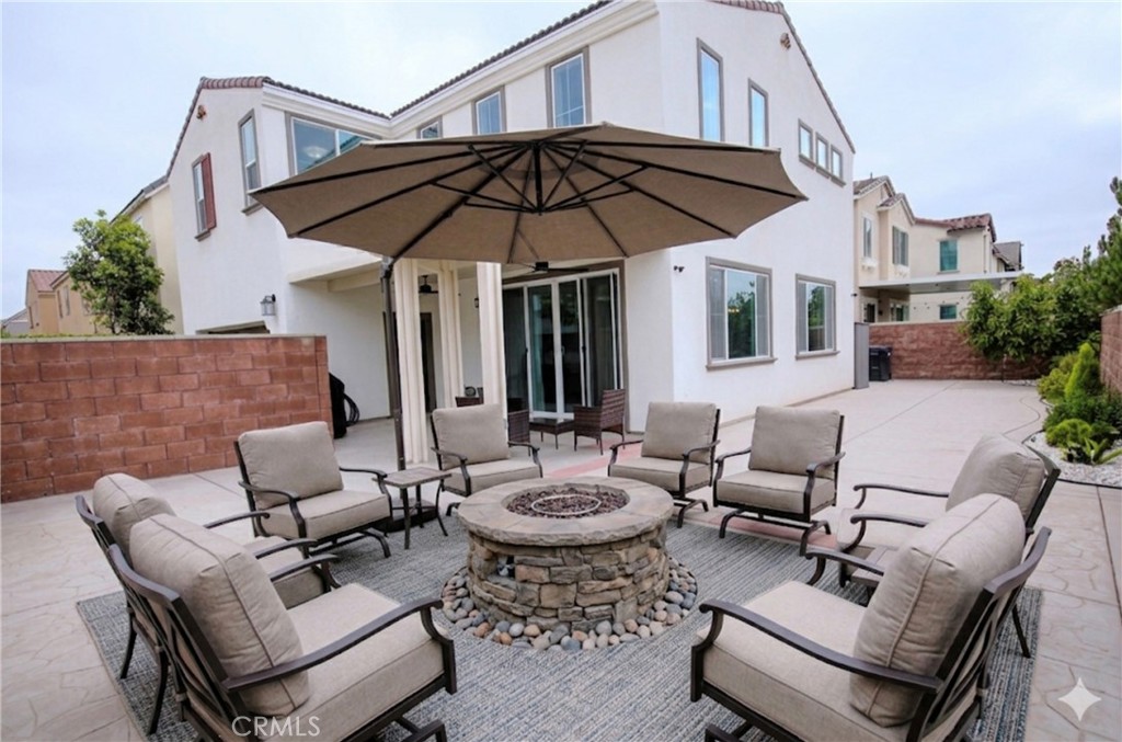 8529 Exposition Street Chino, CA 91708 - Photo 28 of 42 a patio with tables and chairs