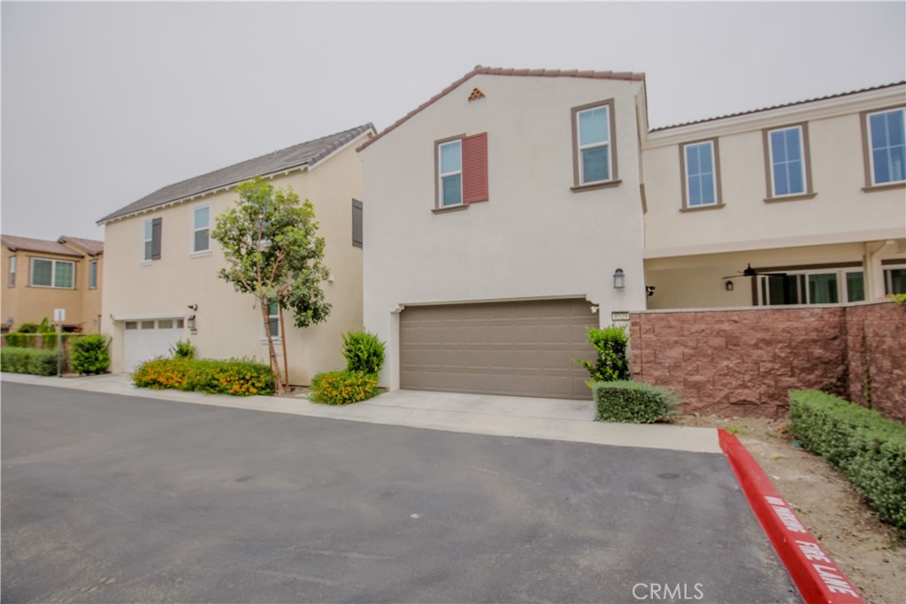8529 Exposition Street Chino, CA 91708 - Photo 32 of 42 a front view of a house with a yard and a garage