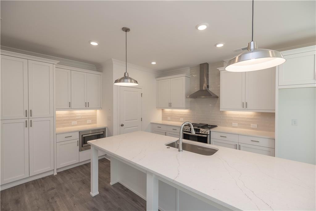 2240 Siskin Sq Road, Unit 88 Duluth, GA 30096 - Photo 14 of 42 a kitchen with a sink a stove and chairs