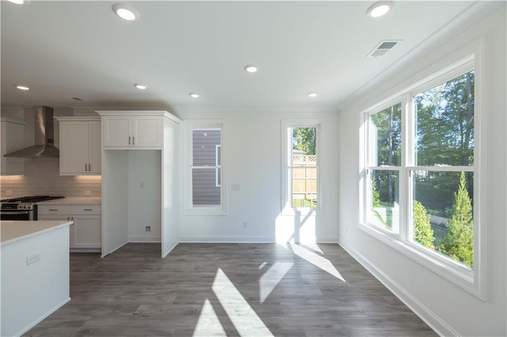 2240 Siskin Sq Road, Unit 88 Duluth, GA 30096 - Photo 18 of 42 a open kitchen with white cabinets and wooden floor