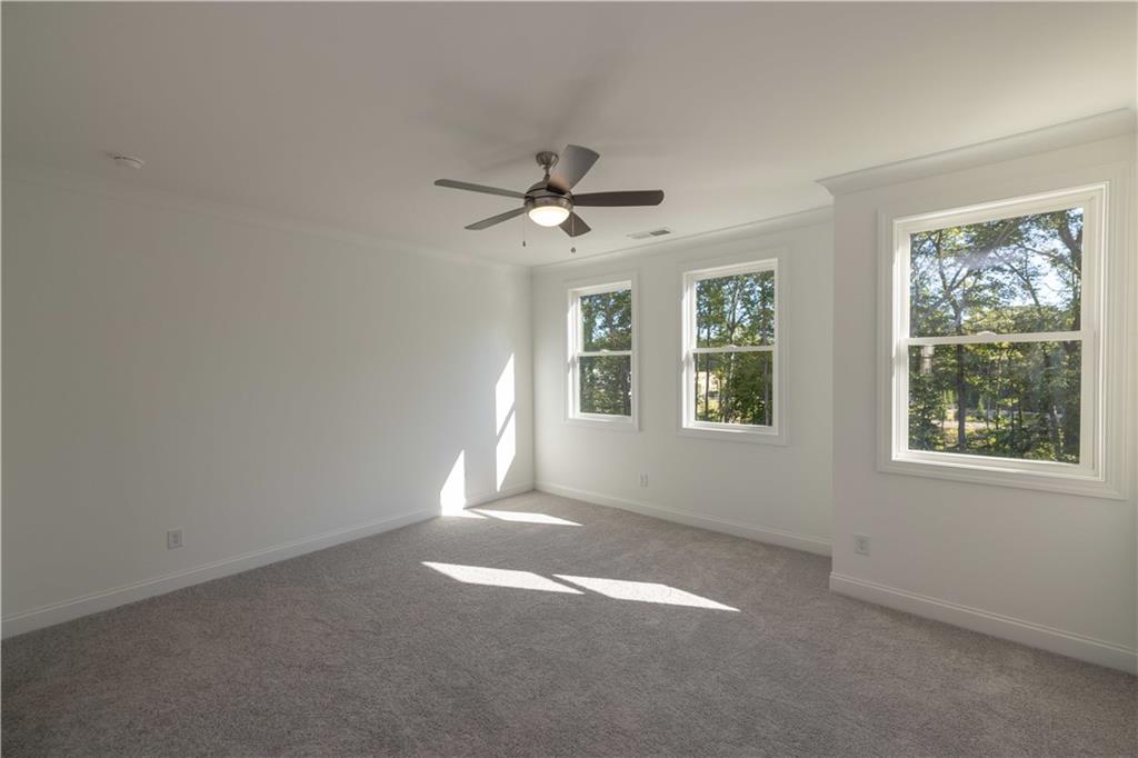 2240 Siskin Sq Road, Unit 88 Duluth, GA 30096 - Photo 21 of 42 an empty room with windows and chandelier fan