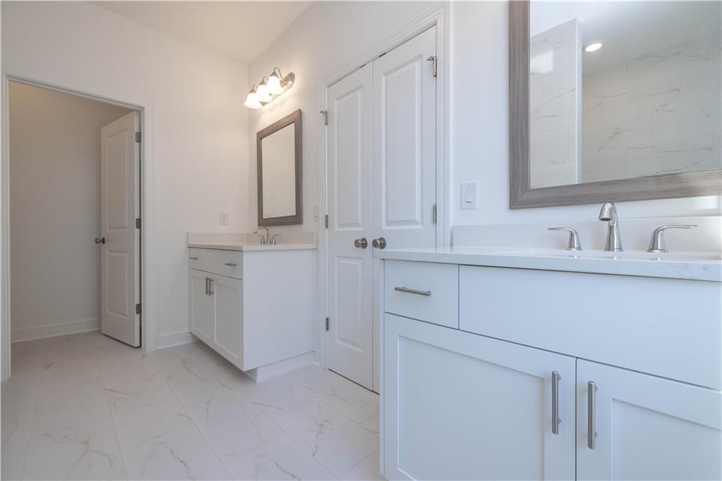 2240 Siskin Sq Road, Unit 88 Duluth, GA 30096 - Photo 24 of 42 a bathroom with a sink vanity and mirror