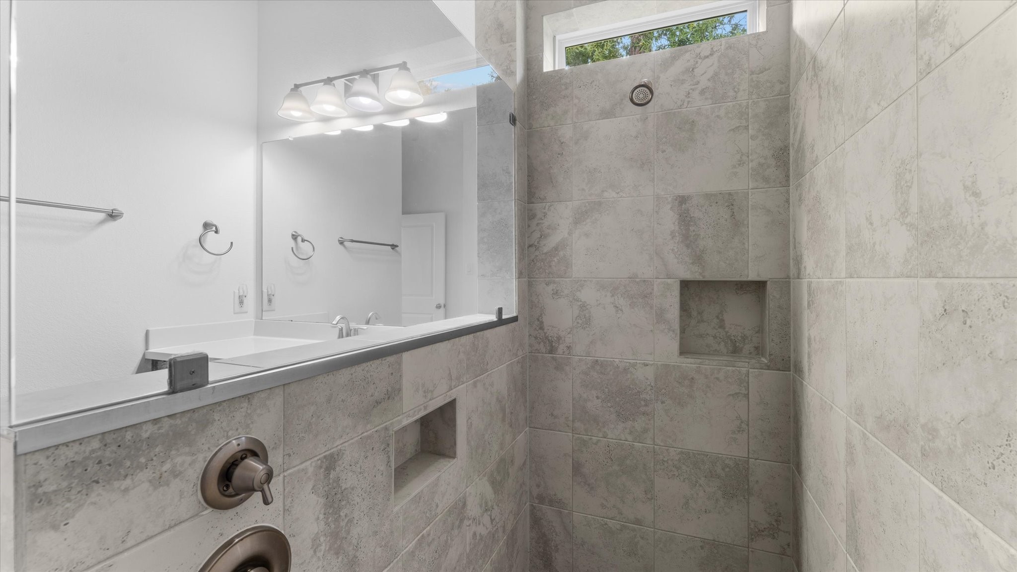 32001 Birch Briar Court Spring, TX 77386 - Photo 32 of 48 Modern tiled walk-in shower with built-in niche, upgraded fixtures, and stylish spa-inspired finishes.