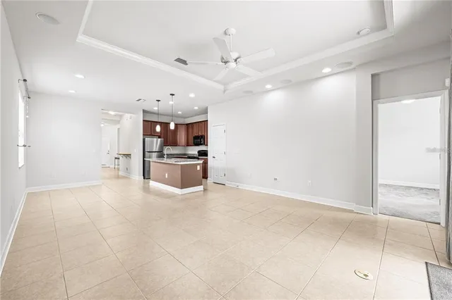 a large white kitchen with a stove a refrigerator and a sink