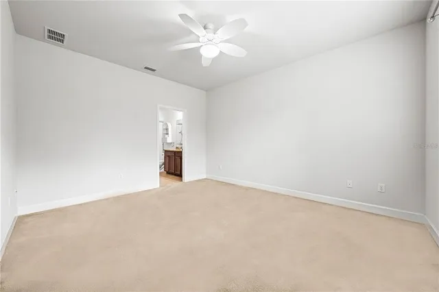 a view of an empty room with a ceiling fan