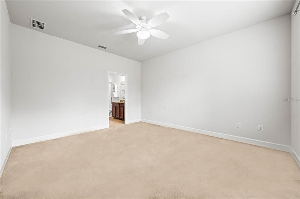 8437 Nandina Drive Sarasota, FL 34240 - Photo 14 of 26 a view of an empty room with a ceiling fan
