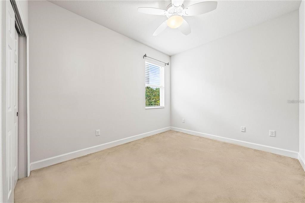 8437 Nandina Drive Sarasota, FL 34240 - Photo 18 of 26 an empty room with a window and a fan