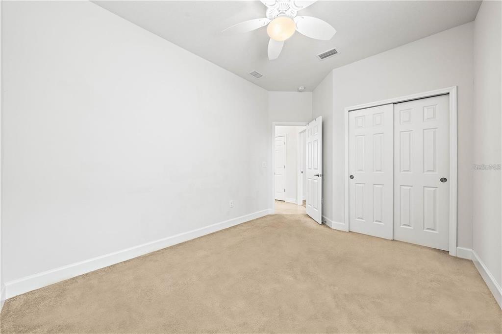 8437 Nandina Drive Sarasota, FL 34240 - Photo 19 of 26 an empty room with a chandelier fan