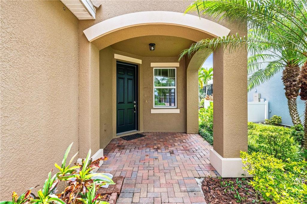 8437 Nandina Drive Sarasota, FL 34240 - Photo 2 of 26 a front view of a house with a blue gate