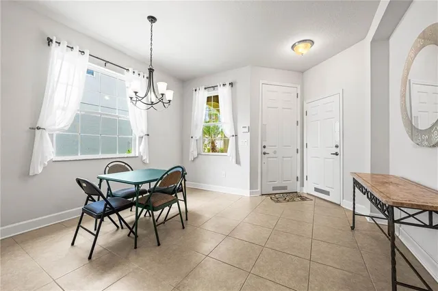 a view of a dining room with furniture and a window