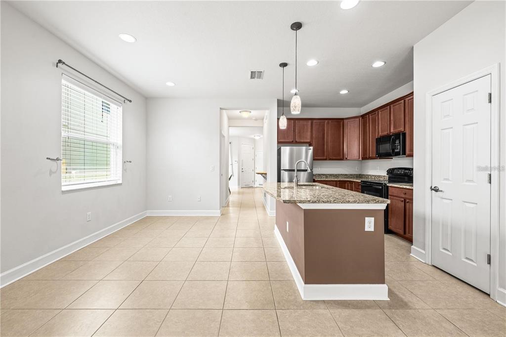 8437 Nandina Drive Sarasota, FL 34240 - Photo 9 of 26 a kitchen with stainless steel appliances granite countertop a refrigerator a sink a stove top oven and a refrigerator
