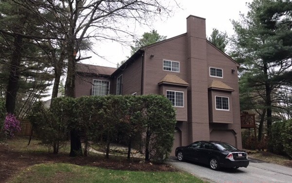 a car parked in front of a white house