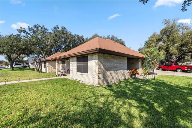 a front view of house with yard and green space
