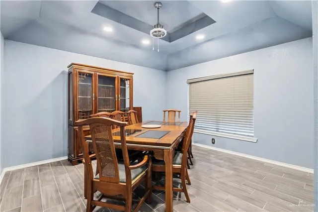 a view of a dining room with furniture and wooden floor