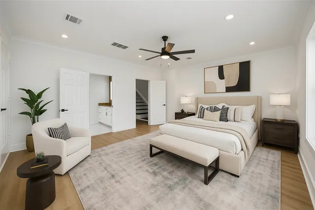 a spacious bedroom with a bed and a couch