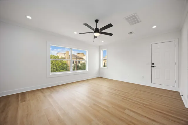 wooden floor in an empty room with a window