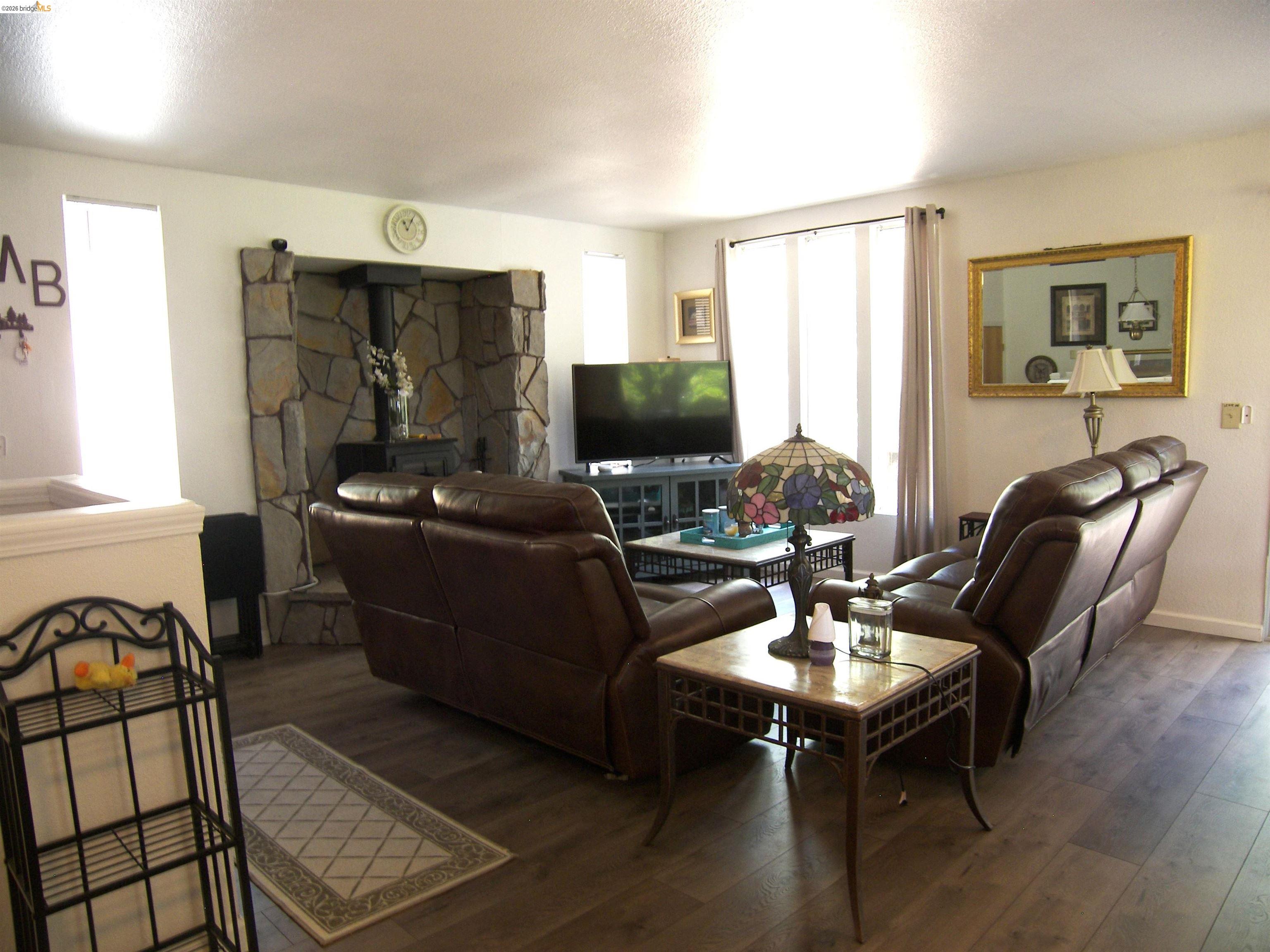 19215 Ferretti Road Groveland, CA 95321 - Photo 7 of 40 Living area featuring a stone-clad fireplace, wood-finish flooring, and recessed lighting