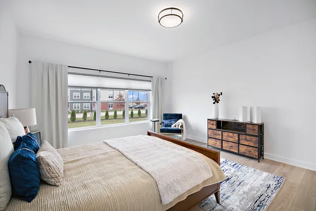 a spacious bedroom with a bed and a large window