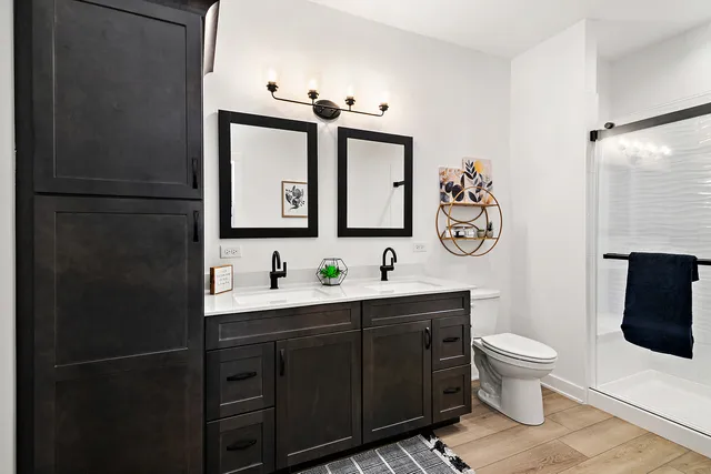 a bathroom with a toilet sink shower and mirror