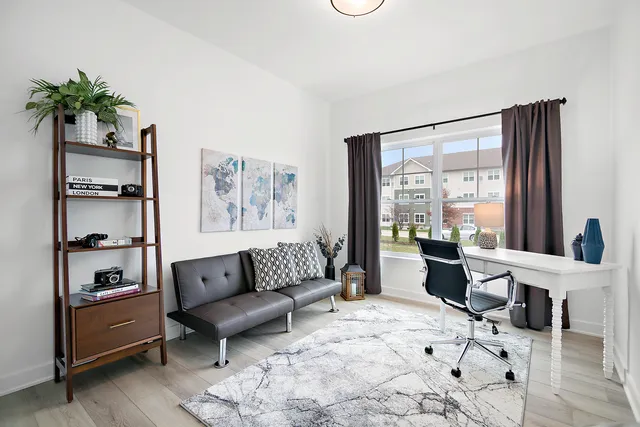 a living room with furniture lamp and window